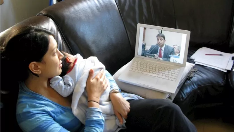 Mother with baby watching news
