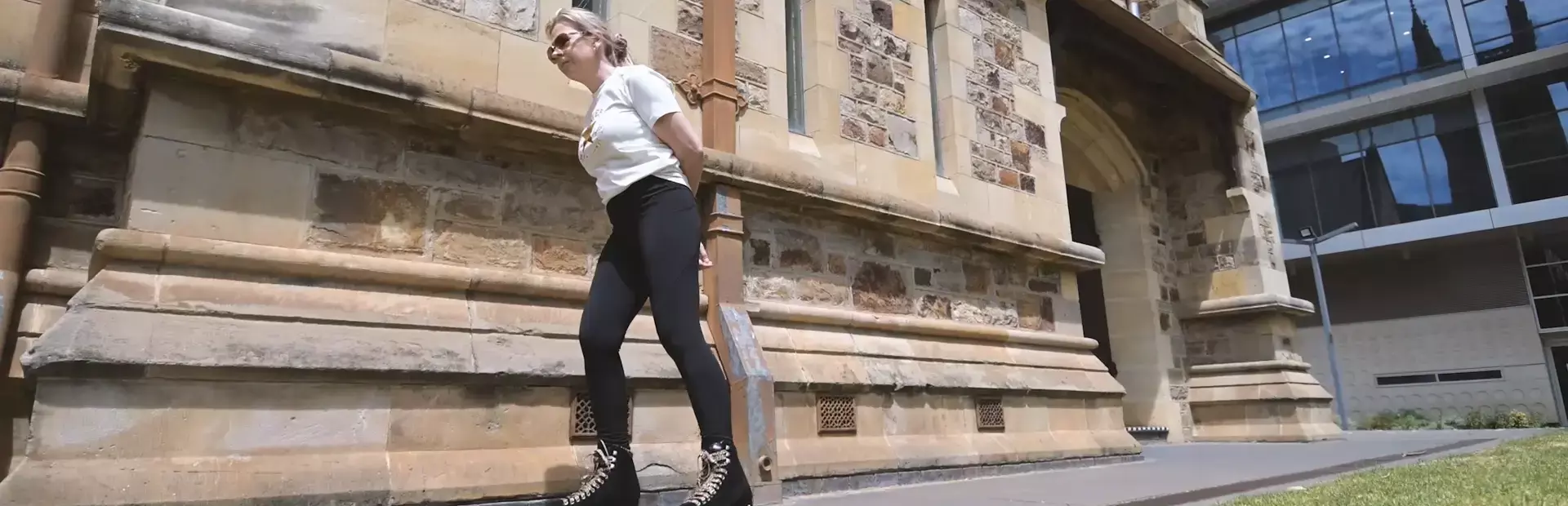 victoria-roller-skates-past-a-historic-stone-building