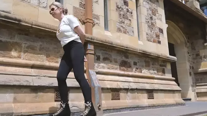 victoria-roller-skates-past-a-historic-stone-building